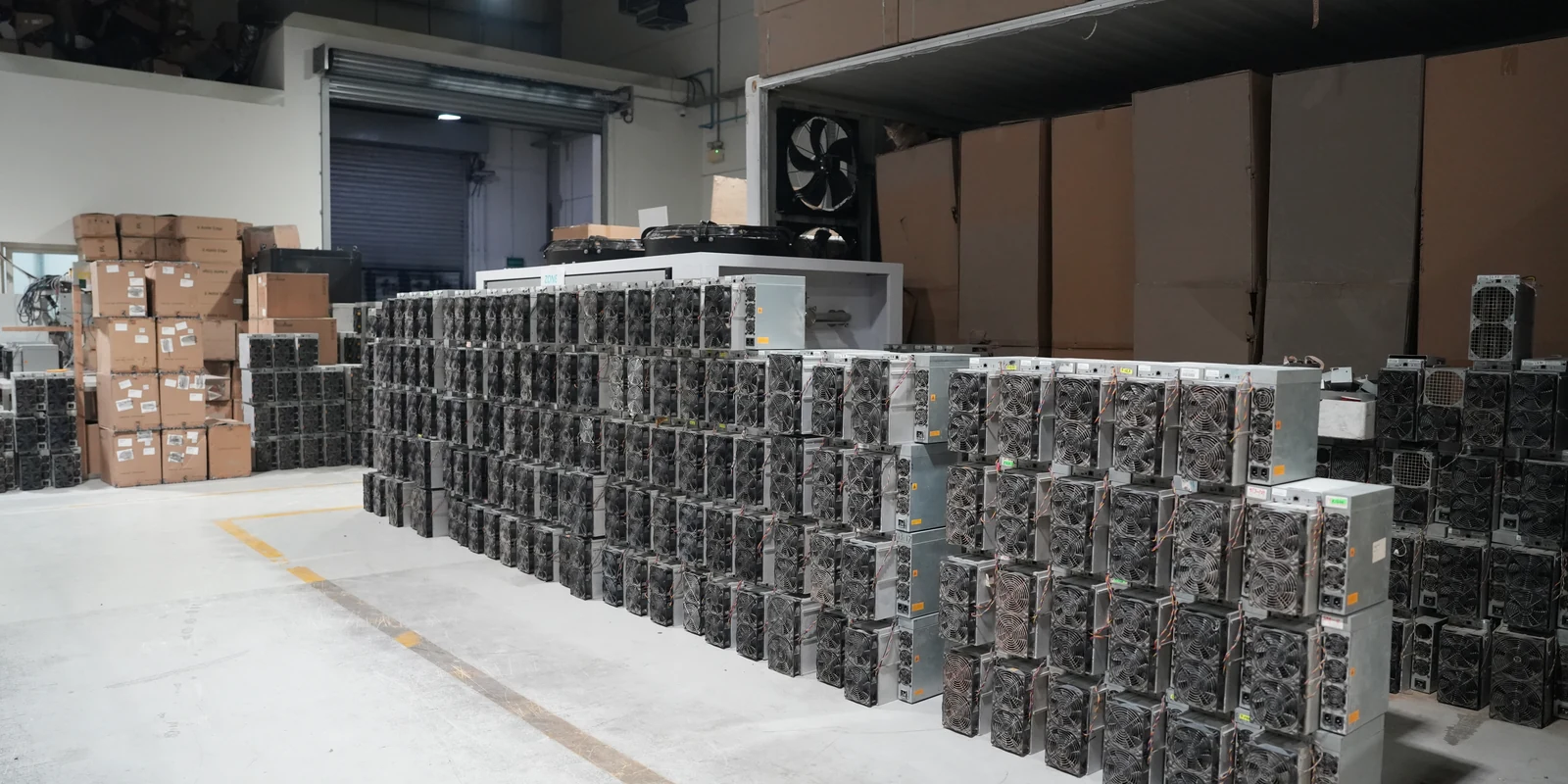Racks of air-cooled Antminer units on the CryptoMiners floor