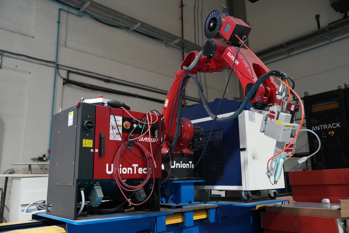 Robotic weld cell fabricating a rack frame