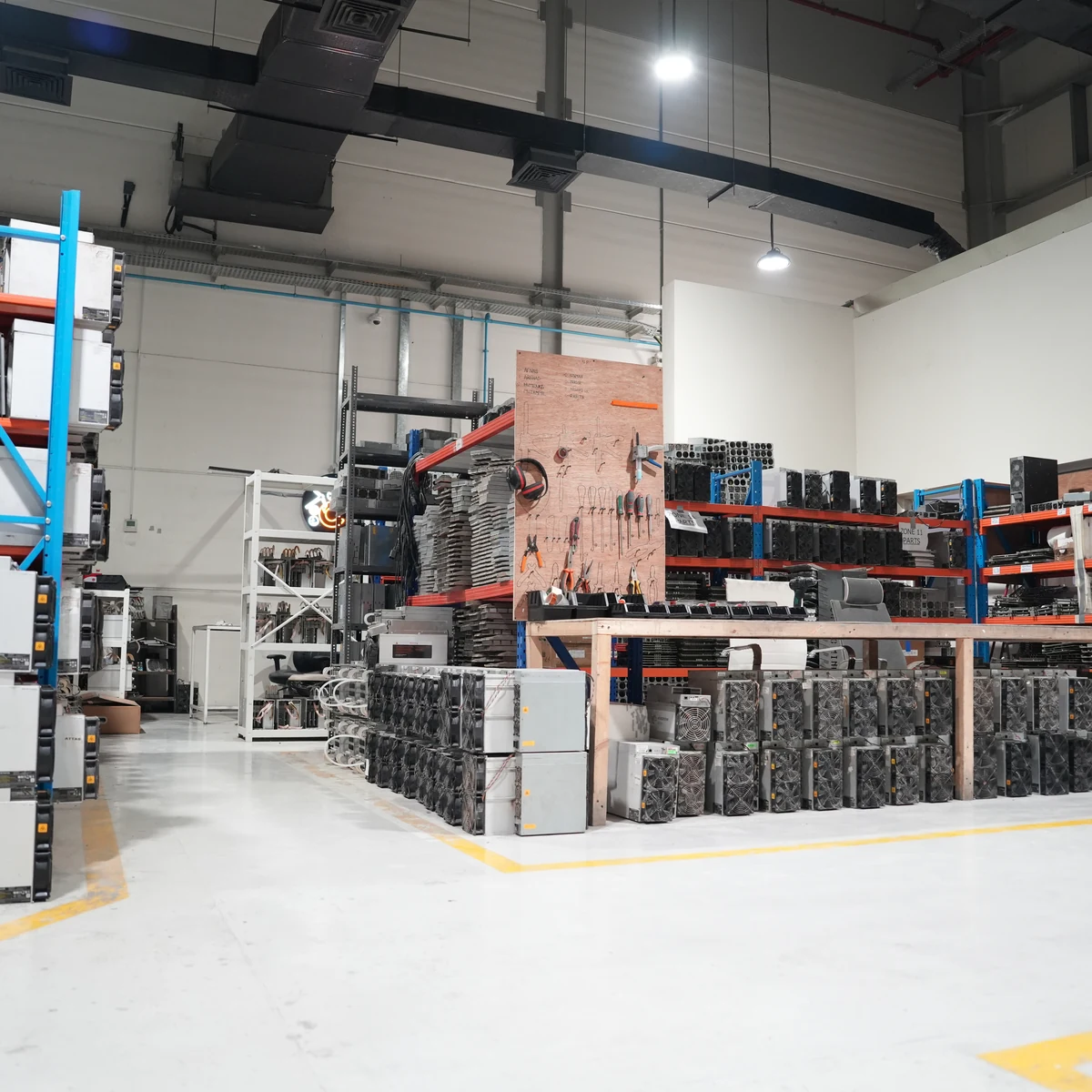 Racked ASIC miners across the shelves of the operations floor