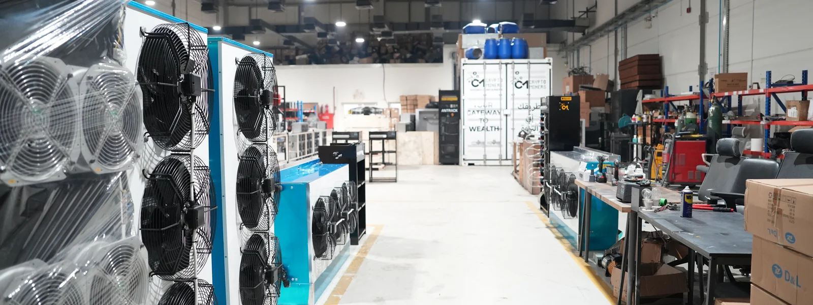 Aisles of air- and hydro-cooled ASIC miners under management on the CryptoMiners hosting floor